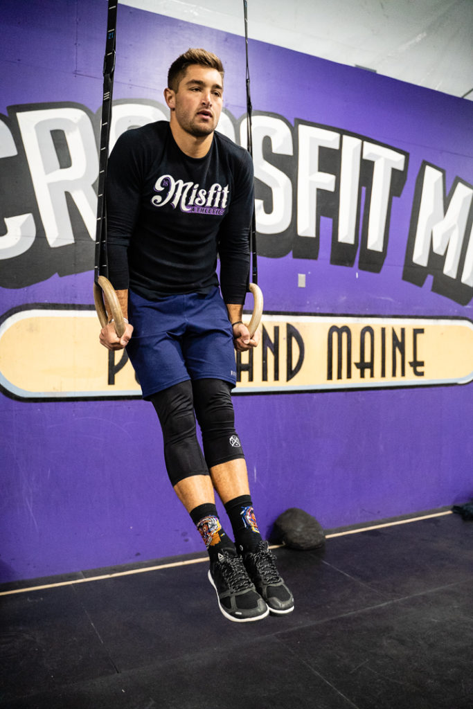 Athlete holding the top of a ring dip