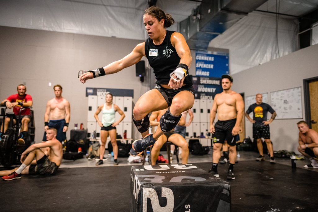 paige semenza jumping over a box during crossfit workout